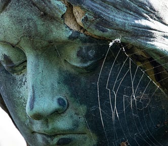 the head of a statue of a woman with closed eyes.