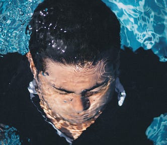 Man holding breath underwater
