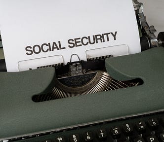 A piece of paper inserted into an old-fashioned typewriter reads “Social Security.”