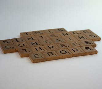 scrabble letters that say this sentence contains 3 errors