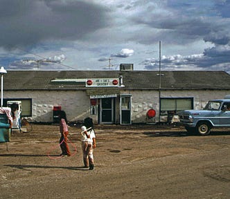 Native children at a village store without supervision.