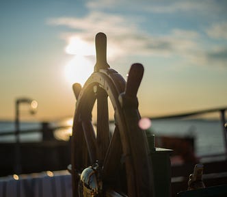 ships wheel at sunset