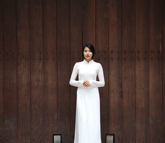 Beautiful Vietnamese woman staying in a long white dress