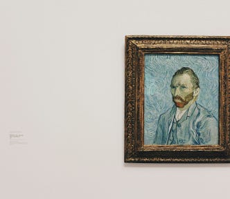 A self-portrait of Van Gogh placed against a wall.