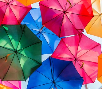 Bright umbrellas, open, against a blue sky