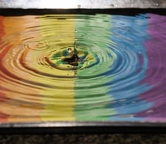 A drop of rain on a rainbow surface