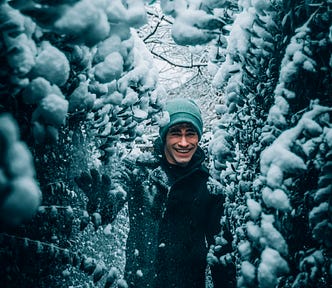 A man has fun in the moment playing in the snow.