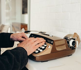 Picture of hands typing on a typewriter