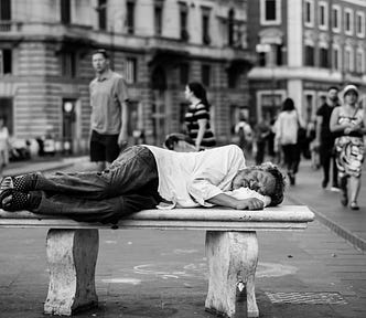 picture of homeless man lying on a bench