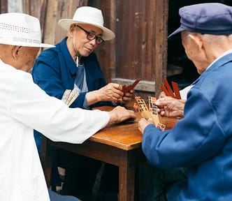 Old men at table playing a game