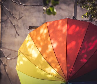 An umbrella, protecting someone from… I don’t know, sun? It’s not raining.