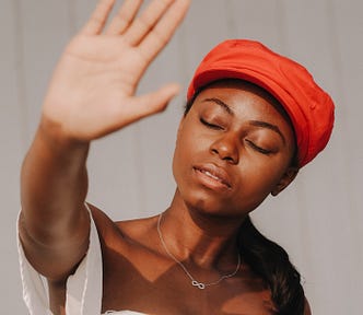 Girl in red hat, eyes closed who is frustrated with her daily gratitude practice.