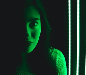 Woman bathed in green light