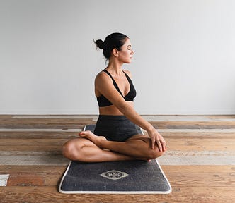 Photo of a woman doing yoga on a yoga mat