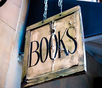 Wooden sign hanging from chains that says BOOKS