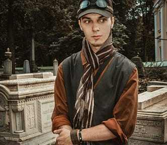 A young man in a scarf and hat