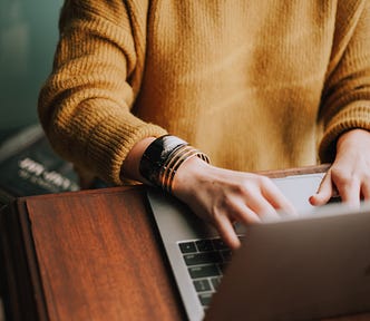 person typing on a laptop