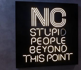 A neon sign about stupidity