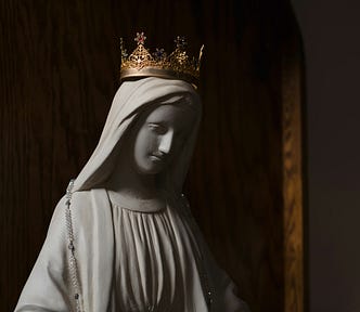 statue of Virgin Mary in a dark church