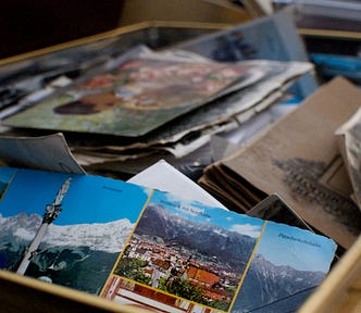 The image is a picture of a box full of postcards.