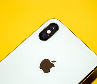 iPhone X on a yellow surface