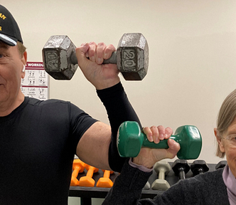 Man and woman holding dumbbells