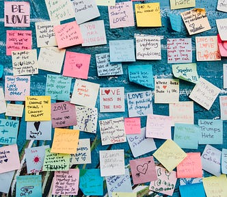 A blue painted wall full of various post-its to show how multiple ideas on a particular topic could be endless; like a big brainstorm event for multiple stories on the same subject.