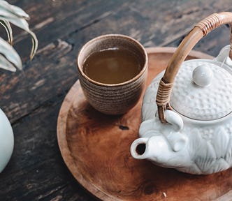 Photo of a tea cup and tea pot.