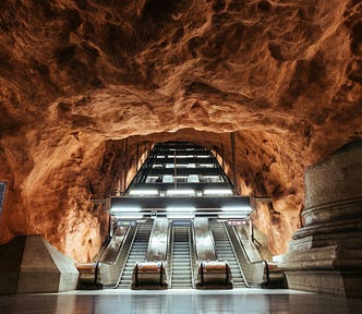 escalators in a rough-hewn rock cave