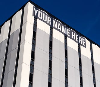 A sign at the top of a building that says ‘Your Name here’.