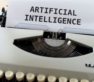 pic shows a typewriter that says “ Artificial Intelligence”