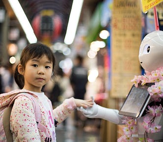 a small child holding hands with a humanoid robot