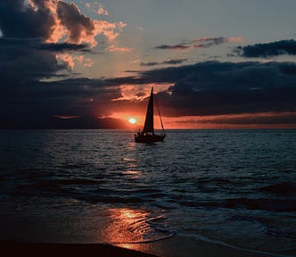 Sunset on the bay with sailboat