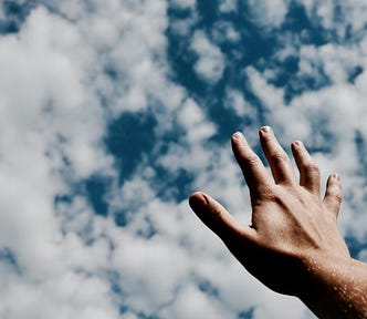 A hand reaches for the sky