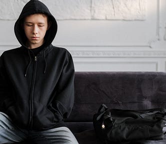Teenager in black hoodie, probably having his own struggles.
