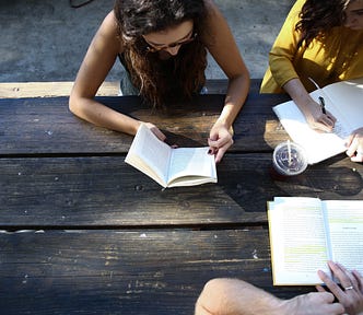 3 girls reading & writing together