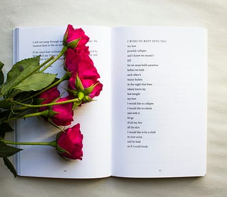 Open book of poetry with roses…