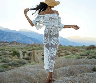 Woman posing with a transparent white dress and a hat