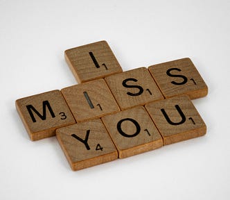 “I miss you” spelled out in Scrabble tiles