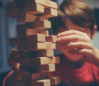 A child playing the “Jenga Tower” game