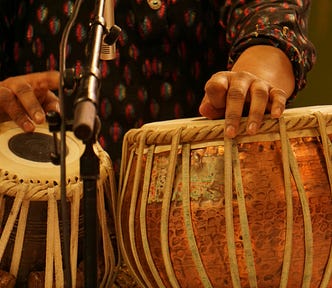 Image of hands playing the tabla, a percussion music instrument