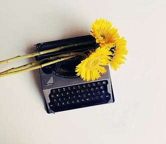 typewriter with flowers on top