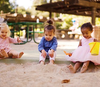 Three kids on the playground having fun