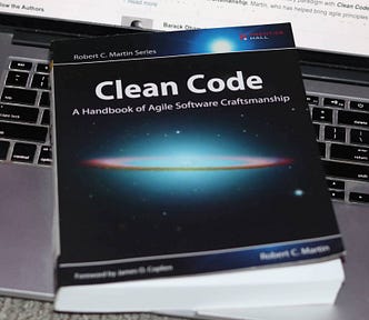 An Image showing Clean Code book by Robert C Martin on top of a laptop keyboard.