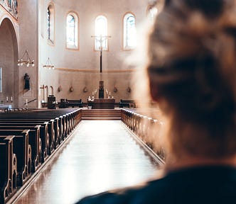 Photo of a woman looking at empty pews