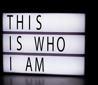 Lit up sign “THIS IS WHO I AM”
