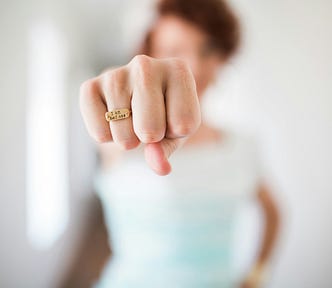 woman’s fist with a ring