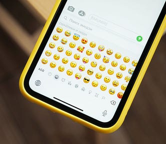 Photo of a phone displaying the emoji keyboard.