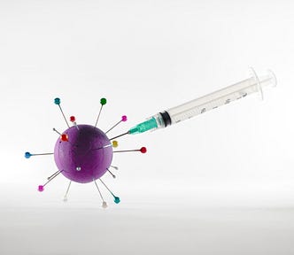 A needle jabbing the COVID virus