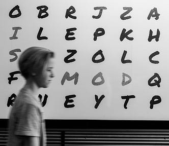 Boy in front of random letters